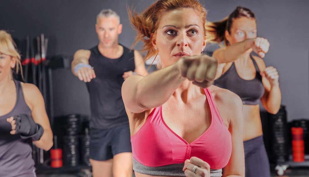 People in a boxing class training punch